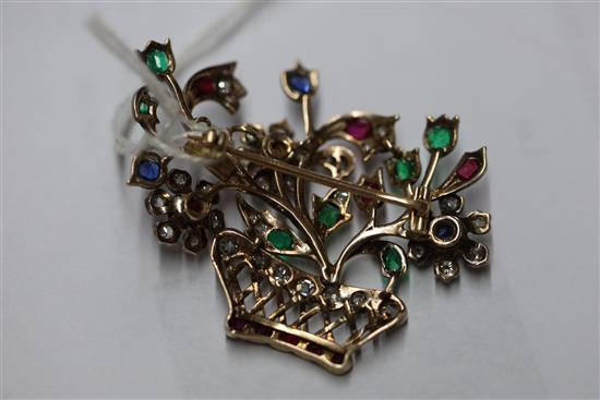 An early 20th century gold and multi gem set guiardinetto (flowers in a basket) brooch, gross 9.9 grams.